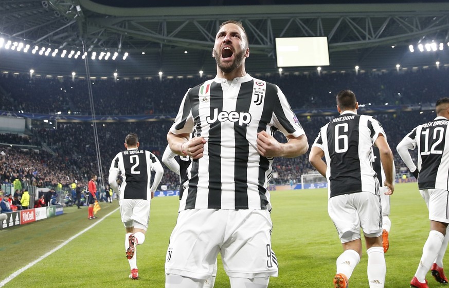 Juventus&#039; Gonzalo Higuain celebrates after scoring his side&#039;s opening goal during the Champions League, round of 16, first-leg soccer match between Juventus and Tottenham Hotspurs, at the Al ...