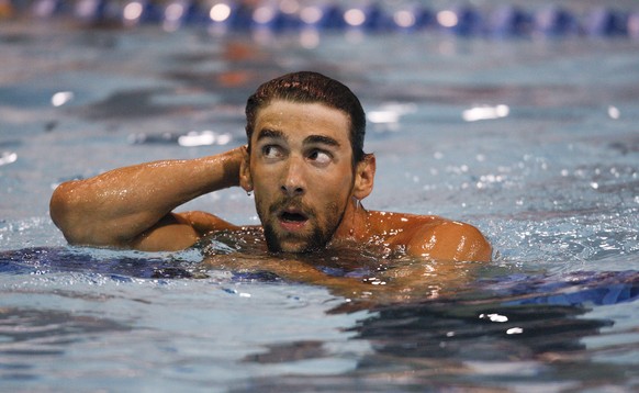 FILE - In this Friday, May 16, 2014 file photo, Michael Phelps looks at the scoreboard after winning the 100-meter butterfly at the Arena Grand Prix swim meet in Charlotte, N.C. Olympic champion swimm ...