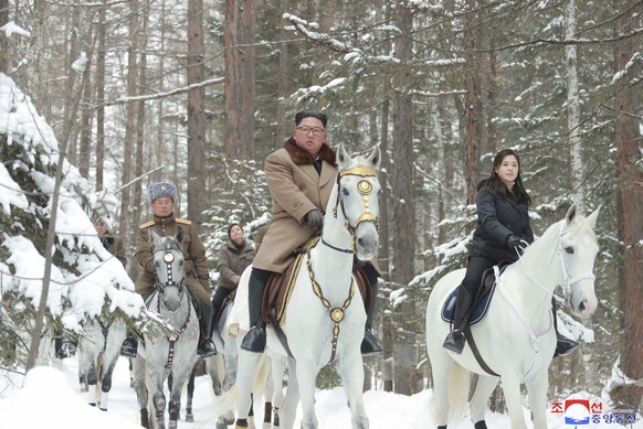 This undated photo provided on Wednesday, Dec. 4, 2019, by the North Korean government shows North Korean leader Kim Jong Un, center, riding on a white horse during his visit to Mount Paektu, North Ko ...