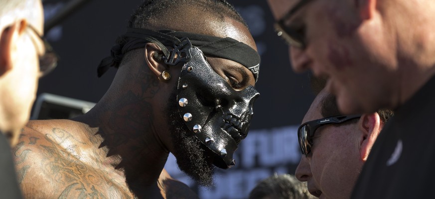 WBC heavyweight titleholder boxer Deontay Wilder keeps a mask on during his official weigh-in ceremony Friday, Nov. 30, 2018, at Staples Center in Los Angeles, ahead of his bout against boxer Tyson Fu ...