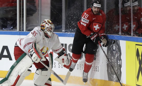 Belarus&#039; Kevin Lalande, left, challenges for the puck Switzerland&#039;s Denis Hollenstein, right, during the Ice Hockey World Championships group B match between Switzerland and Belarus in the A ...