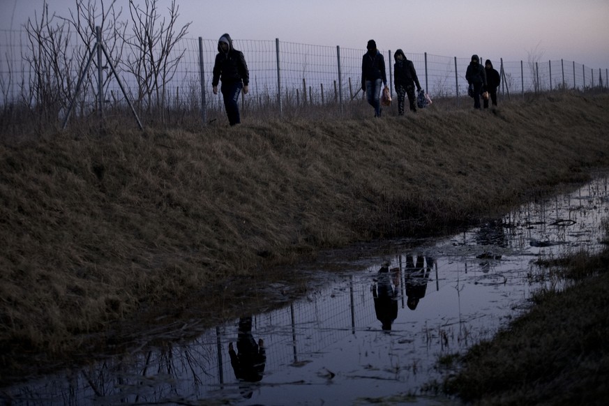 Migranten aus Afghanistan laufen an der Grenze von Serbien zu Ungarn englang, in der Hoffnung, einen Weg in die EU zu finden. (AP Photo/Marko Drobnjakovic)