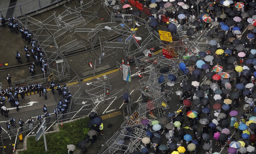 Protesters gather outside the Legislative Council in Hong Kong, Wednesday, June 12, 2019. Thousands of protesters blocked entry to Hong Kong&#039;s government headquarters Wednesday, delaying a legisl ...