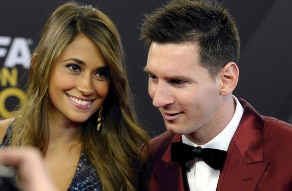 Soccer player Lionel Messi, right, of Argentina arrives with his wife Antonella Roccuzzo, left, on the red carpet prior to the FIFA Ballon d&#039;Or 2013 gala held at the Kongresshaus in Zurich, Switz ...