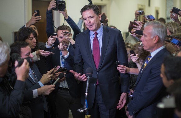epa07248891 YEARENDER DECEMBER 2018

Former FBI Director James Comey (C) speaks to the news media after a daylong closed door hearing for the House of Representatives Judiciary Committee at the US C ...