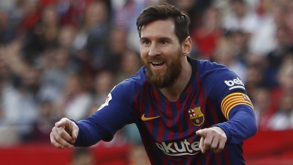 Barcelona forward Lionel Messi celebrates after scoring his side&#039;s second goal during La Liga soccer match between Sevilla and Barcelona at the Ramon Sanchez Pizjuan stadium in Seville, Spain. Sa ...