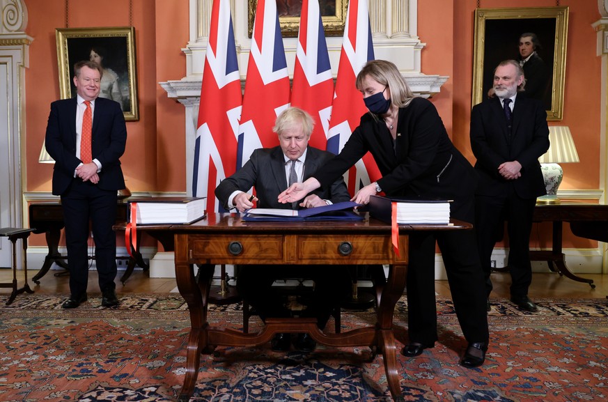 epa08911631 A handout photo made available by n10 Downing street shows Britain&#039;s Prime Minister Boris Johnson after signing the Trade and Cooperation Agreement between the UK and the EU, the Brex ...