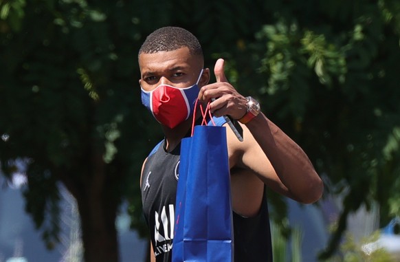 epa08653187 (FILE) Paris Saint Germain player Kylian Mbappe wearing a protective face mask leaves after a training session at the Camp des Loges sports complex near Paris, France, 25 June 2020, re-iss ...