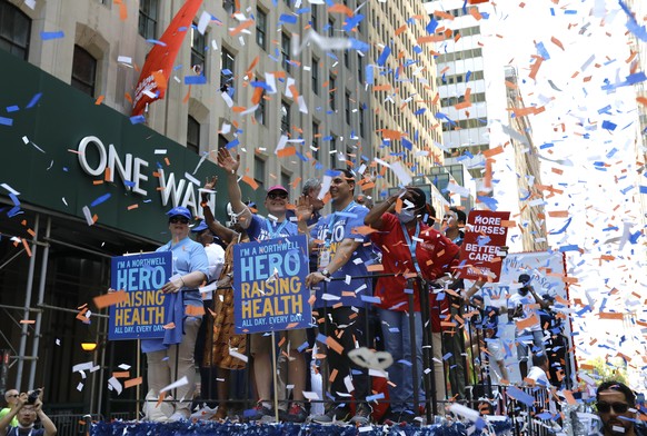 epa09329671 Health and Hospital workers ride up the Canyon of Heroes in lower manhattan at the Hometown Heroes Ticker Tape Parade in New York, New York, USA, 07 July 2021. Today&#039;s parade honors e ...