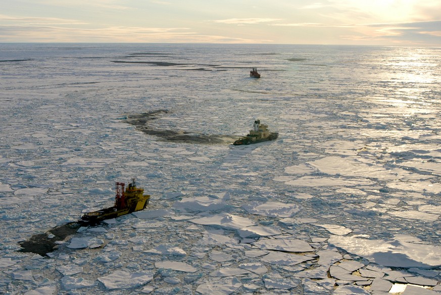 This photo provided by the University of Rhode Island shows three research ships breaking through arctic ice a few miles from the North Pole as scientists drill deep below the surface in August 2004.  ...