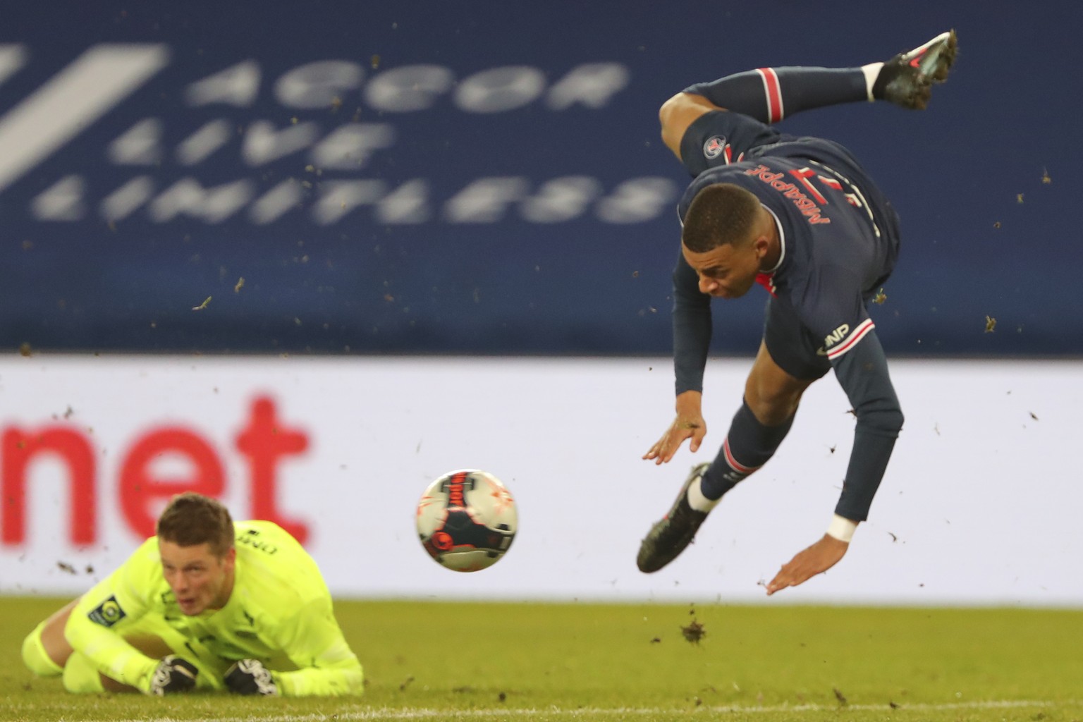 PSG&#039;s Kylian Mbappe, right, jumps over Montpellier&#039;s goalkeeper Jonas Omlin during the French League One soccer match between Paris Saint-Germain and Montpellier at the Parc des Princes stad ...