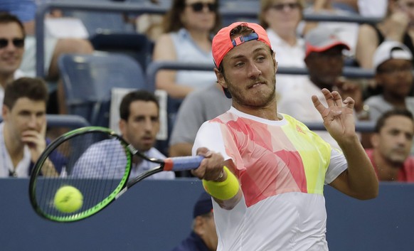 epa05517669 Lucas Puille of France hits a return to Marco Chiudinelli of Switzerland on the third day of the US Open Tennis Championships at the USTA National Tennis Center in Flushing Meadows, New Yo ...