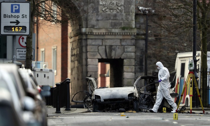 Forensic investigators at the scene of a car bomb blast on Bishop Street in Londonderry, Northern Ireland, Sunday, Jan. 20, 2019. Northern Ireland police and politicians have condemned a &quot;reckles ...