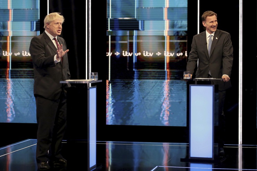 In this photo issued by ITV, showing Britain&#039;s Conservative Party leadership candidates Boris Johnson, left, and Jeremy Hunt, during a live head-to-head TV debate hosted by ITV at their studios i ...