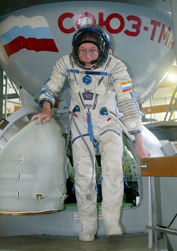 In this photograph released by Space Adventures, American space tourist Gregory Olsen steps out of the Soyuz-TMA spacecraft capsule model in the Gagarin Vosmonaut Training Center in Star City near Mos ...