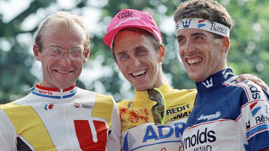 In this July 23, 1989 photo, French rider Laurent Fignon, left, American rider Greg LeMond, center, and Spanish rider Pedro Delgado pose on the podium following LeMond&#039;s victory in the 76th Tour  ...