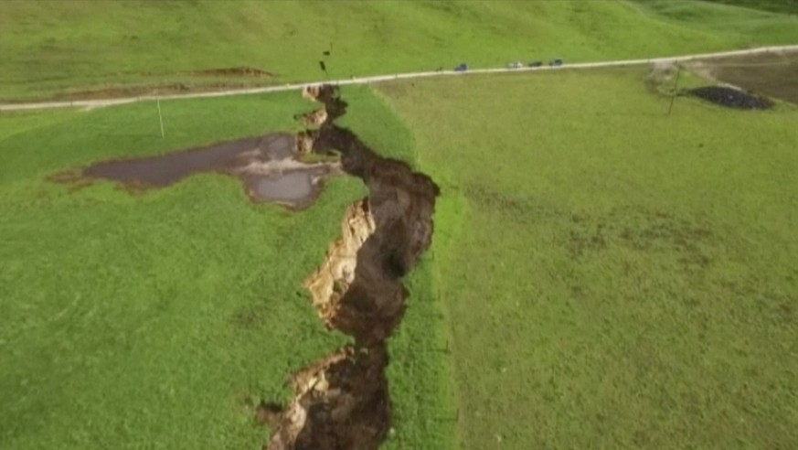 This image made from the May 2, 2018 video shows huge sinkhole on farm in Rotorua, New Zealand. A spectacular sinkhole the length of two football fields and the depth of a six-story building has opene ...