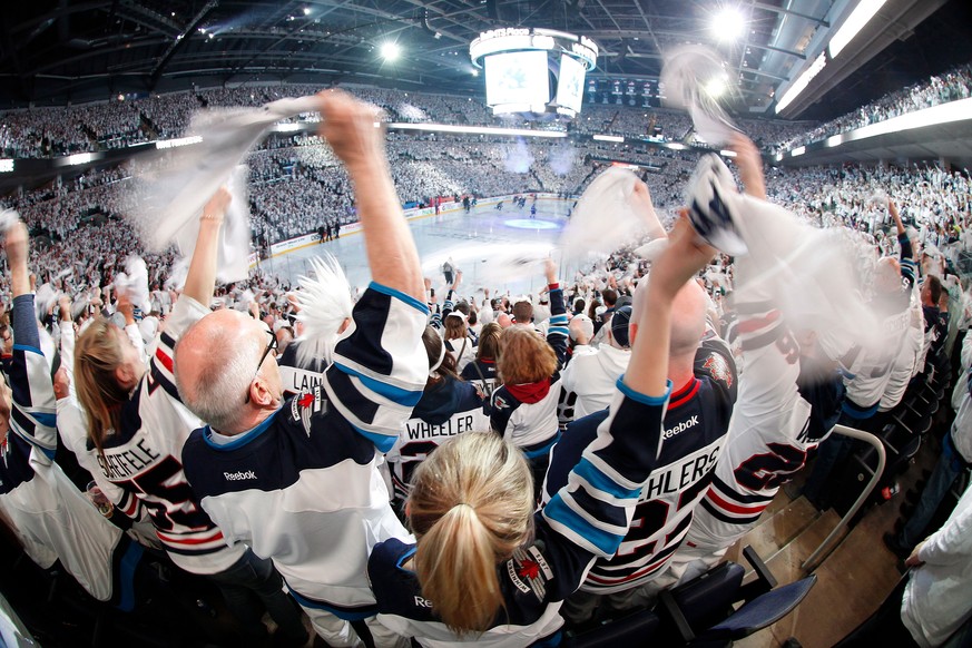 Winnipeg Jets fans cheer on the team as players hit the ice before Game 1 in an NHL hockey first-round playoff series against the Minnesota Wild, Wednesday, April 11, 2018, in Winnipeg, Manitoba. (Joh ...