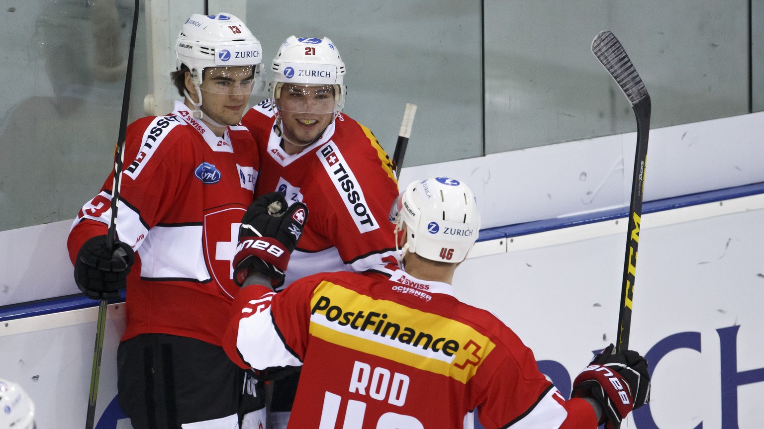 Switzerland&#039;s forward Nico Hischier, left, celebrates his goal with teammates forward Kevin Fiala, center, and forward Noah Rod, right, after scoring the 3:1, during a friendly international ice  ...