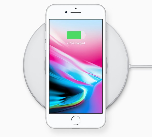 epa06200822 A handout photo made available by Apple Inc., shows the Apple iPhone 8 on a wireless charger as introduced at the new Steve Jobs Theater during the Apple Special Event at the new Apple Hea ...