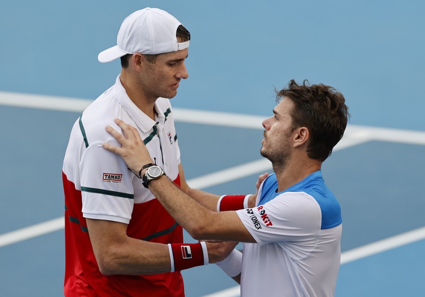 John Isner, left, of the U.S. shakes hands with Switzerland&#039;s Stan Wawrinka after retiring from their third round match at the Australian Open tennis championship in Melbourne, Australia, Saturda ...