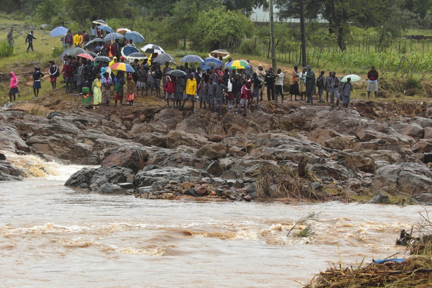 Schoolchildren are stranded across a collapsed bridge in Chimanimani, southeast of Harare, Zimbabwe, Monday, March 18, 2019. (AP Photo/Tsvangirayi Mukwazhi)