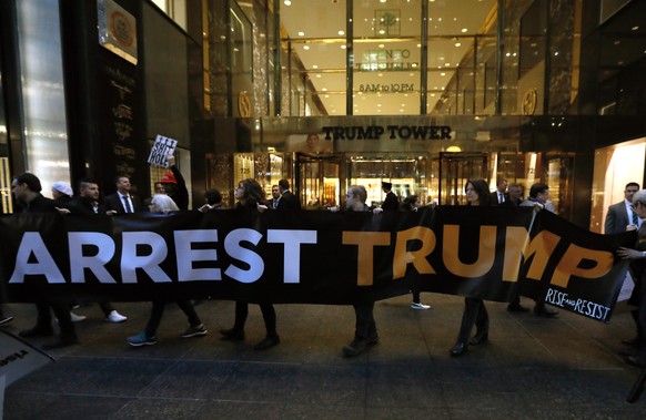 epa07346570 Protesters carry signs and banners outside of Trump Tower in New York, New York, USA, 05 February 2019. The protest comes just hours before US President Donald J. Trump is scheduled to giv ...
