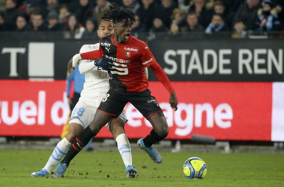 Rennes&#039; Eduardo Camavinga, front, duels for the ball with Marseille&#039;s Jordan Amavi during the League One soccer match between Rennes and Marseille, at the Roazhon Park stadium in Rennes, Fra ...