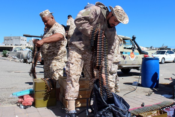 epaselect epa07492516 Militants, reportedly from the Misrata militia, prepare their weapons and ammunition before heading to the frontline to join forces defending the capital, in Tripoli, Libya, 08 A ...