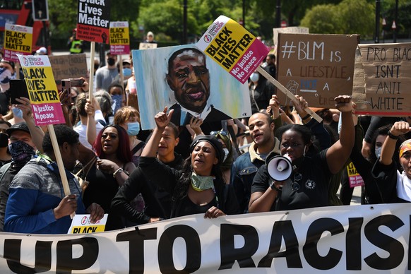 Members of Black Lives Matter movement chant slogans during a protest at Hyde Park in London, Saturday, June 13, 2020. British police have imposed strict restrictions on groups planning to protest in  ...