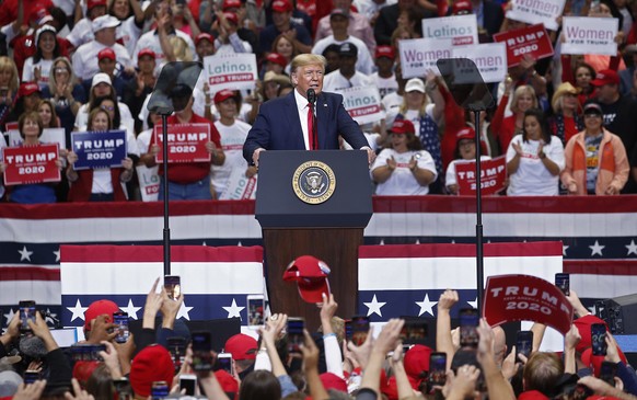 epa07928940 US President Donald J. Trump (C) speaks to supporters during a campaign rally inside the American Airlines Center in Dallas, Texas, USA, 17 October 2019. The US presidential elections are  ...