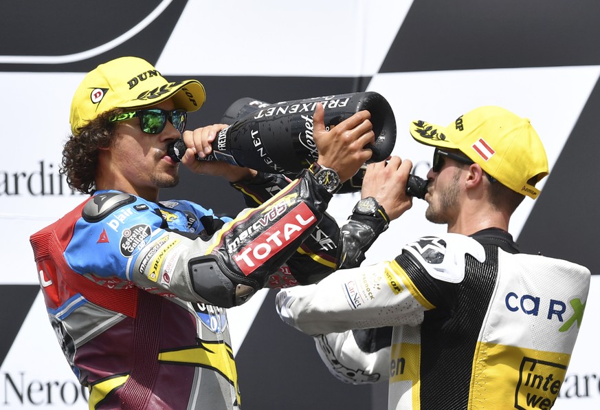 Third placed Switzerland&#039;s Thomas Luthi of the CarXpert Interwetten, right, and Moto2 race winner Italian rider Franco Morbidelli of the EG 0,0 Marc VDS team celebrate at the Moto2 race at the Au ...