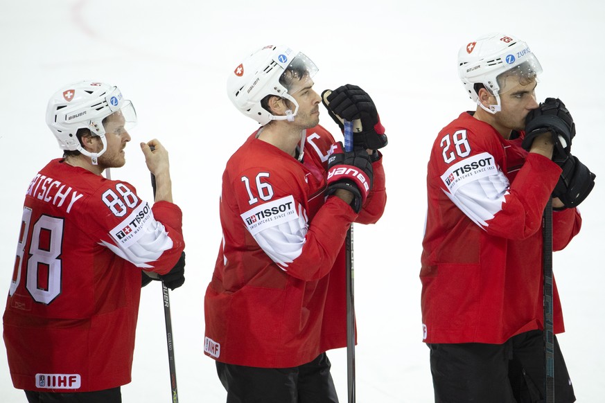 epa09235040 (L-R) - Switzerland&#039;s players forward Christoph Bertschy, defender Raphael Diaz and forward Timo Meier look disappointed after losing the IIHF 2021 Ice Hockey World Championship Group ...