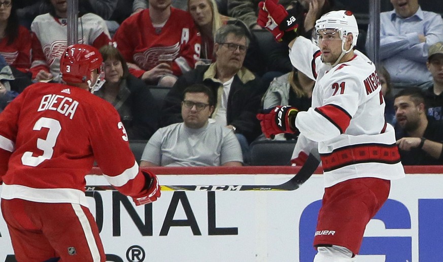 Carolina Hurricanes right wing Nino Niederreiter (21) celebrates his second-period goal in front of Detroit Red Wings defenseman Alex Biega (3) during an NHL hockey game Tuesday, March 10, 2020, in De ...