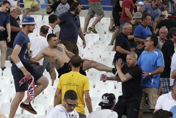 FILE - In this file photo taken on Thursday, June 9, 2016, clashes break out in the stands after the Euro 2016 Group B soccer match between England and Russia, at the Velodrome stadium in Marseille, F ...