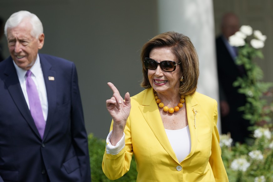 House Speaker Nancy Pelosi of Calif., right, and House Minority Whip Steny Hoyer, D-Md., left, arrive for an event in the Rose Garden of the White House in Washington, Monday, July 26, 2021, to highli ...