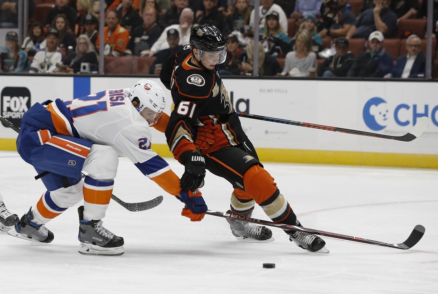 New York Islanders defenseman Luca Sbisa, left, of Italy, defends, as Anaheim Ducks right wing Troy Terry overskates the puck during the second period of an NHL hockey game in Anaheim, Calif., Wednesd ...
