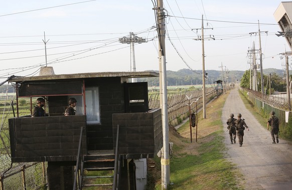 FILE - In this June 15, 2020, file photo, South Korean army soldiers patrol along the barbed-wire fence in Paju, South Korea, near the border with North Korea. A North Korean diplomat who served as th ...