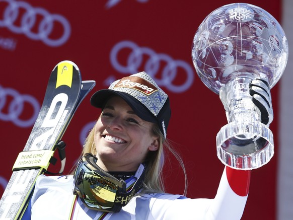 FILE - In this March 20, 2016 file photo Lara Gut of Switzerland holds the crystal globe trophy of the women&#039;s overall title at the alpine ski World Cup finals in St. Moritz, Switzerland. The fir ...