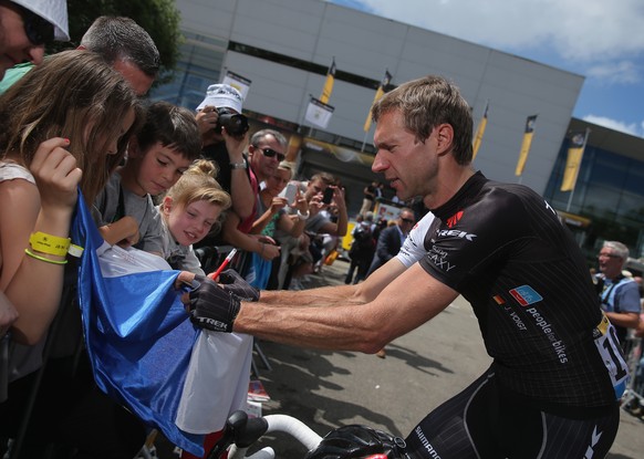 MULHOUSE, FRANCE - JULY 14: Jens Voigt of Germany and Trek Factory Racing signs autographs for fans priro to stage ten of the 2014 Le Tour de France from Mulhouse to La Planche des Belles Filles on Ju ...