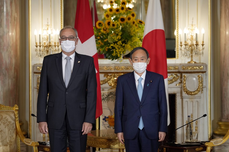 Japanese Prime Minister Yoshihide Suga, right, poses with Swiss President Guy Parmelin for a photo ahead of their meeting at the Akasaka State Guest House in Tokyo Saturday, July 24, 2021. (Franck Rob ...