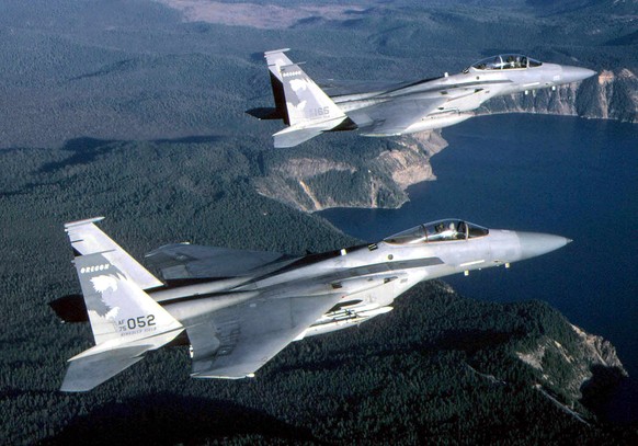 epa08486254 A undated handout photo from the United States Air Force shows two F-15 jet fighters in flight over Crater Lake, Oregon. According to the British defence ministry, a US Air Force F-15C Eag ...