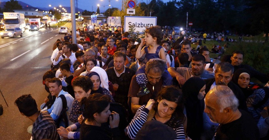 Migrants wait to be registered after crossing the border from Austria in Freilassing, Germany September 16, 2015. Roughly 700 asylum seekers who set off from Salzburg earlier in the day have now cross ...
