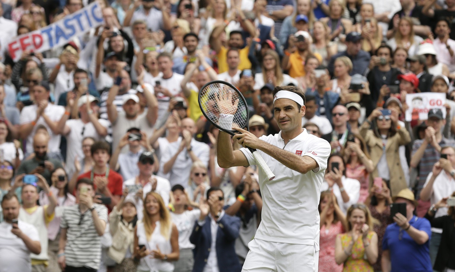 Switzerland&#039;s Roger Federer celebrates after beating Lucas Pouile of France in a Men&#039;s singles match during day six of the Wimbledon Tennis Championships in London, Saturday, July 6, 2019. ( ...