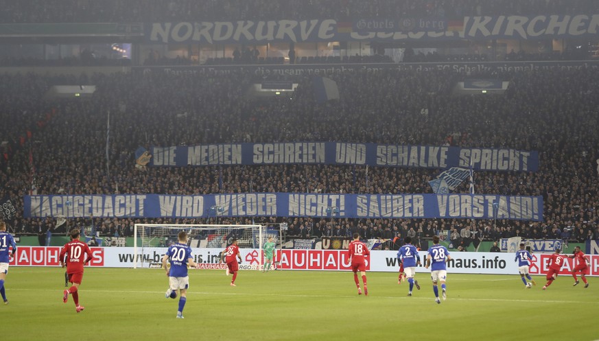epa08267860 Schalke 04 fans display banners during the German DFB Cup quarter final match between Schalke 04 and Bayern Munich in Gelsenkirchen, 03 March 2020. EPA/FRIEDEMANN VOGEL CONDITIONS - ATTENT ...