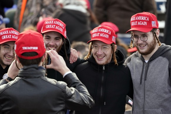 Supporters pose for a photo before President Donald Trump speaks during a campaign rally at Manchester-Boston Regional Airport, Sunday, Oct. 25, 2020, in Londonderry, N.H. (AP Photo/Elise Amendola)