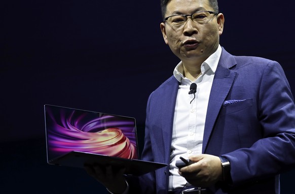 Huawei CEO Richard Yu displays a new Huawei MateBook X Pro laptop at the Mobile World Congress, in Barcelona, Spain, Sunday, Feb. 24, 2019. The fair started with press conferences on Sunday, before th ...