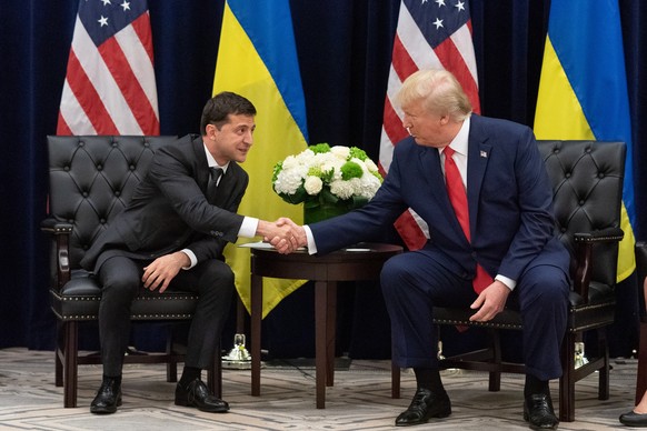 epa07869481 A handout photo made available by Ukraine Presidential Press Service shows Ukraine&#039;s President Volodymyr Zelensky (L) and US President Donald J. Trump (R) during a meeting on the side ...