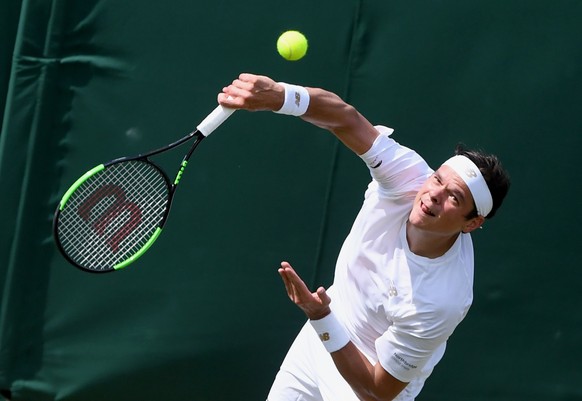 epa07692380 Milos Raonic of Canada in action against Robin Haase of the Netherlands during their second round match at the Wimbledon Championships at the All England Lawn Tennis Club, in London, Brita ...