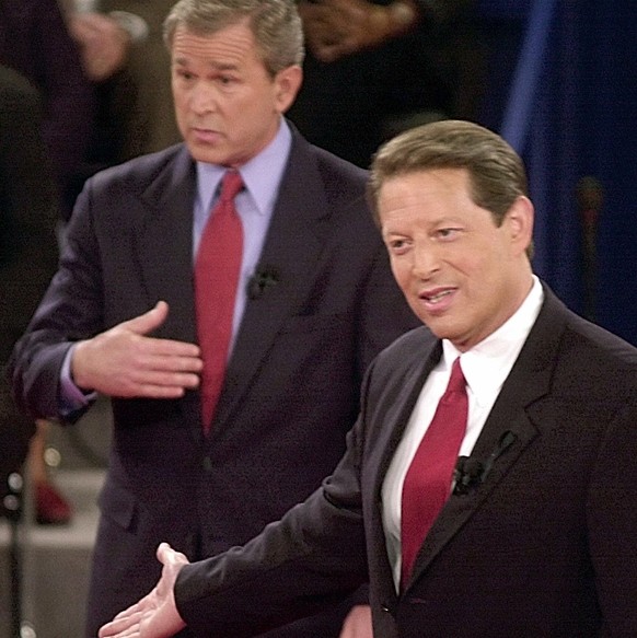 FILE - In this Oct. 17, 2000 file photo, Republican presidential candidate Texas Gov. George W. Bush, left, and Democratic presidential candidate Vice President Al Gore gesture during their third and  ...